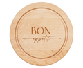 The Maple 12" Round Board features an engraved oval groove and the words "Bon Appetit" elegantly inscribed in the center.