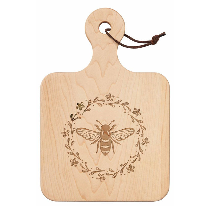 The Maple 12" x 8" Maple Wood Board | Honeybee features a handle, leather loop, and engraved bee with floral wreath—ideal as a charming cheese or charcuterie board for gatherings.