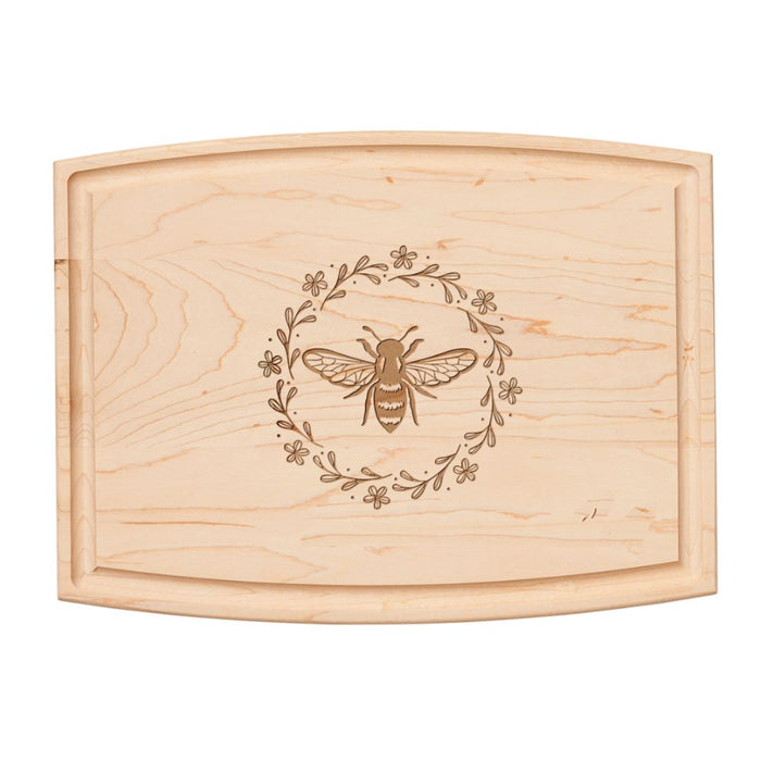The 12" x 9" Arched Maple Board | Honeybee by Maple features an engraved bee at the center with a circular floral wreath—ideal as a cheese or charcuterie board for elegant entertaining.
