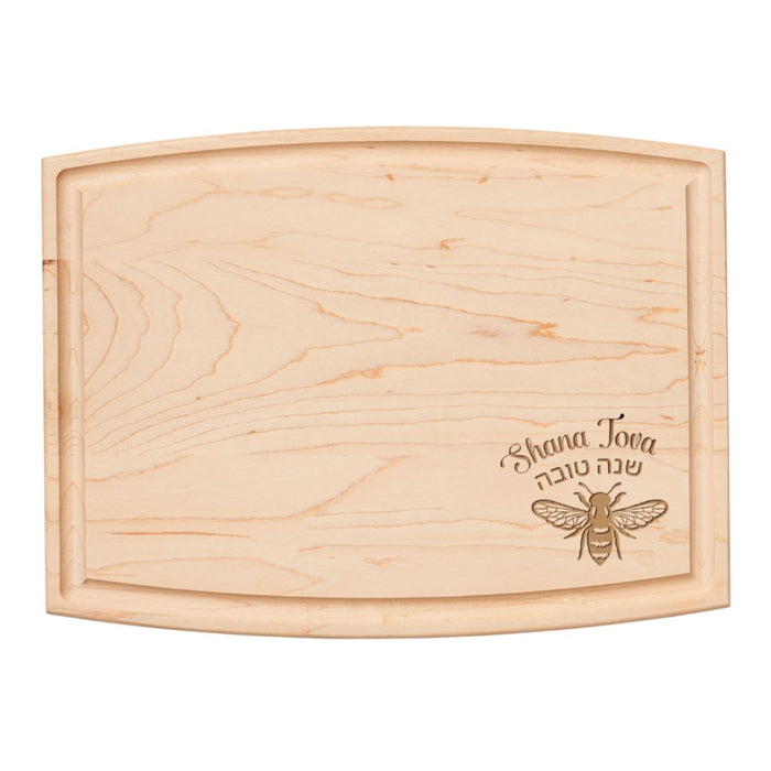 The 12" x 9" Arched Maple Board by Maple is a lightweight hard rock maple cutting board with curved edges, engraved with a bee and “Shana Tova” in English and Hebrew, ideal as a unique charcuterie board.
