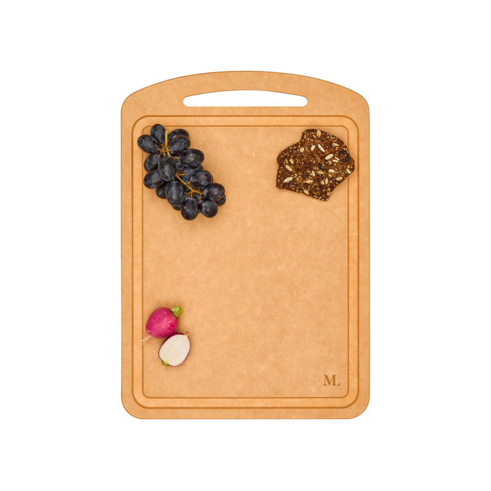 A Maple 14" x 10" Natural Wood Composite Chef Board displays black grapes, two slices of multigrain crispbread, and a whole and halved radish, all arranged neatly against a white background.
