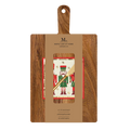 The Sophistiplate 14" x 8" Board Gift Kit: Nutcracker Christmas includes an acacia wood charcuterie board, a gold spreader, and festive nutcracker napkins, all packaged with a brown Maple Leaf at Home label.
