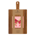 A 14" x 8" wooden serving board with a handle from Sophistiplate, packaged as a gift kit with pink bows napkin and product details on the label.