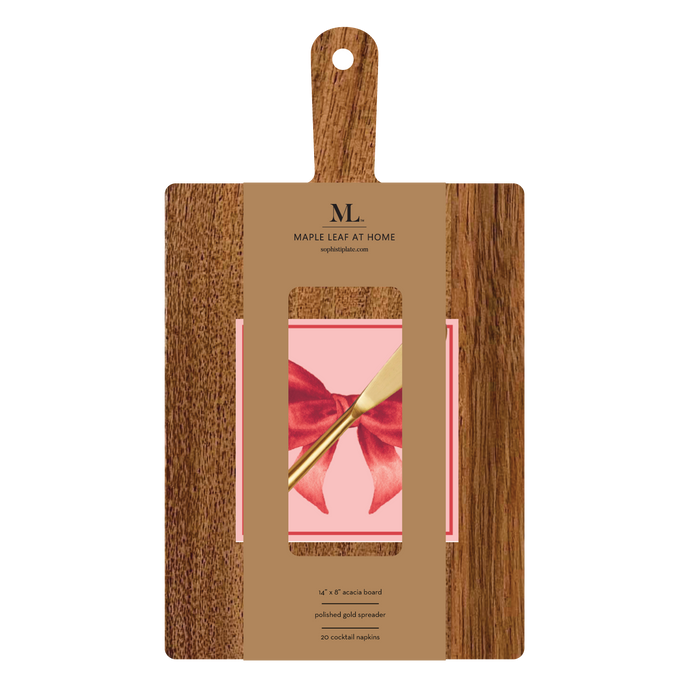 A 14" x 8" wooden serving board with a handle from Sophistiplate, packaged as a gift kit with pink bows napkin and product details on the label.
