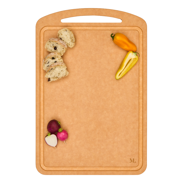 The Maple 18" x 12" Natural Wood Composite Chef Board, with a handle, showcases slices of bread, a yellow bell pepper, and three radishes at the edges while keeping the center clear.
