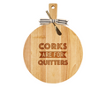 The Maple 19" x 14" Rubber Wood Thick Handle Board features a gold spreader and is engraved with “Corks are for Quitters”—a fun, personalized piece for any gathering.