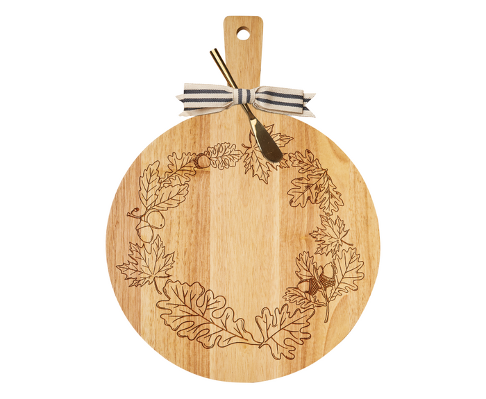 The Maple 19" x 14" Rubber Wood Thick Handle Board with Gold Spreader—Harvest Leaves features an oak leaf and acorn wreath, a striped bow, and a gold-colored cheese knife, making it perfect as a decorative charcuterie board.