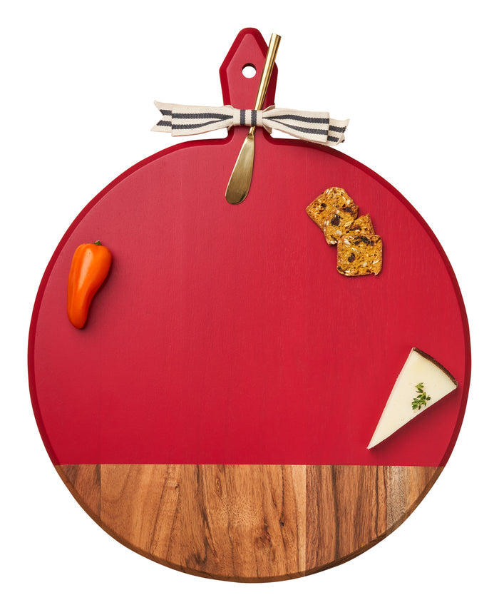 The Maple 20" x 16" Acacia Heirloom Board in Red with Gold Spreader features a red top, wood bottom, and includes a brass knife—an elegant choice for serving cheese and snacks at your next gathering.