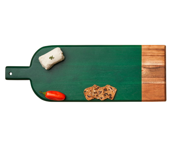 The Maple 20" x 7" Acacia Bevel Board in Green showcases a small goat cheese log, three thin crackers, and a red pepper, all stylishly arranged and spaced apart on a white background.