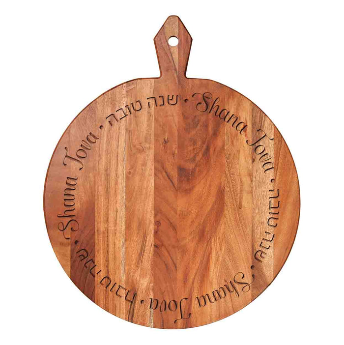 The Maple 20x16" Acacia Heirloom Board Round - Shana Tova Round features "Shana Tova" and its Hebrew equivalent elegantly engraved in a circle, making it a perfect Rosh Hashanah serving board with handle.