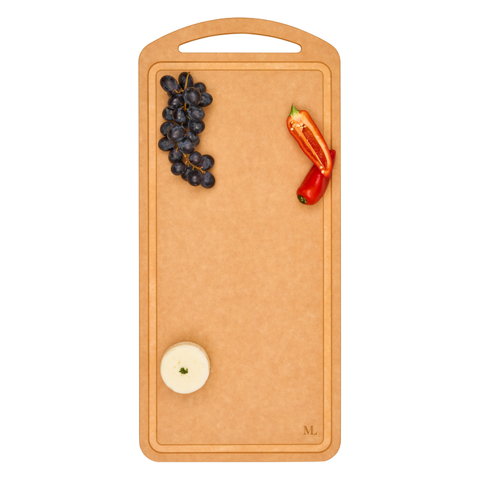 The Maple 22" x 10" Natural Wood Composite Chef Board with a handle displays black grapes, two red pepper halves, and a small wheel of cheese—each arranged separately on a plain white background. Stylish, heat-resistant, and practical.