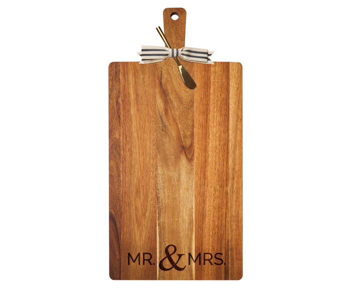 The Maple 24" x 12" Acacia Wood Thick Handle Cutting Board features “Mr & Mrs” engraving, a gold spreader, and a black-and-white striped ribbon, combining elegance and function for your kitchen decor.