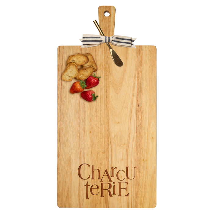 The Maple 24" x 12" Rubber Wood Thick Handle Cutting Board | Charcuterie features “Charcuterie” engraved at the bottom, topped with three strawberries, toasted bread slices, a cheese knife, and a striped ribbon on the handle.