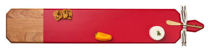 The Maple 34" x 6" Acacia Heirloom Board in Red features a gold spreader and is perfect for serving cheeses, minis, and crackers. Ideal as a laser engraved cheese board for any gathering.