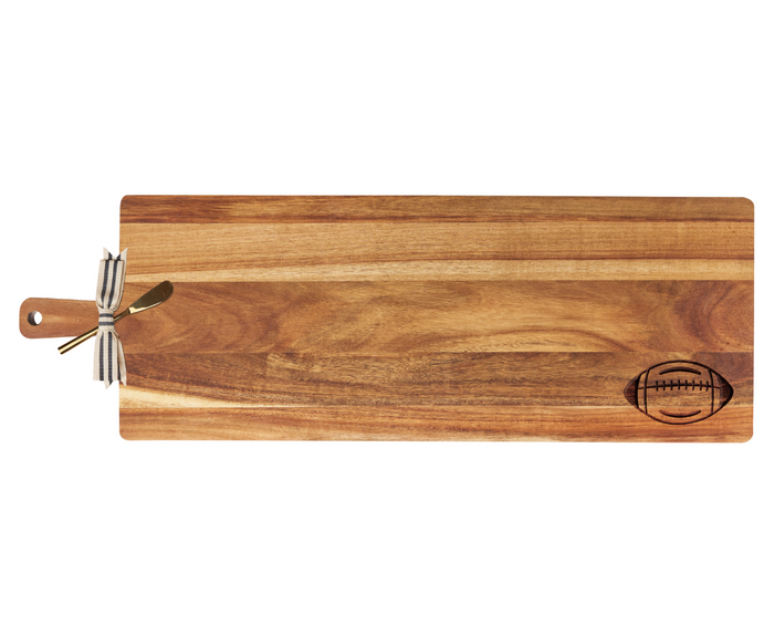 The Maple 35" x 12" Acacia Wood Thick Handle Board with Gold Spreader features a football design—ideal as a personalized charcuterie board or stylish kitchen decor.