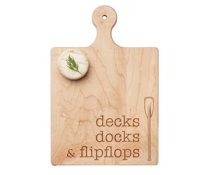 Serve your favorite charcuterie on the Maple 9" x 6" Artisan Maple Paddle Board, engraved with “Decks Docks & Flipflops.” Topped with cheese and dill crackers, it’s perfect for any gathering.