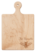 The 9" x 6" Maple Wood Board by Maple is engraved with a honeybee and personalized with your name in the corner—ideal as a charming cheese board.