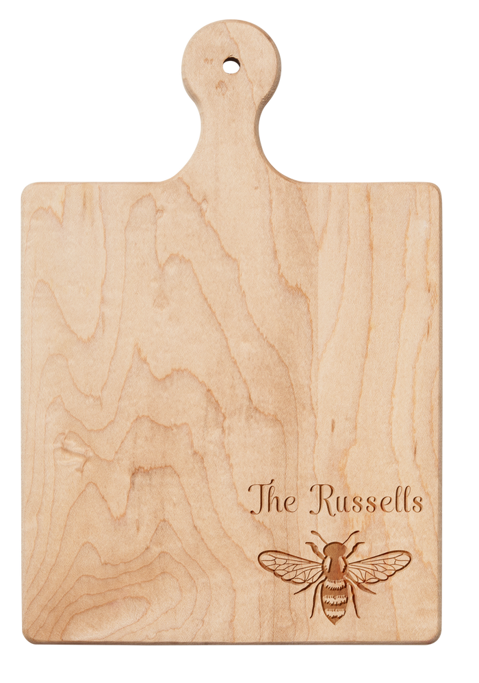 The 9" x 6" Maple Wood Board by Maple is engraved with a honeybee and personalized with your name in the corner—ideal as a charming cheese board.