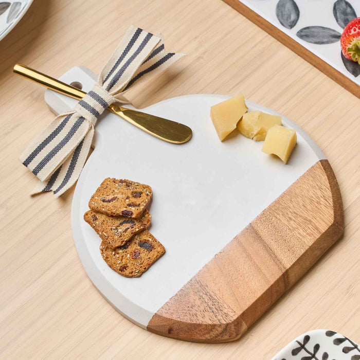 The Sophistiplate 9.75" x 8" Board Gift Kit: Bright & Thankful displays yellow cheese cubes and fruit & nut crackers with a gold knife tied in a striped ribbon, all arranged on a light wood table.