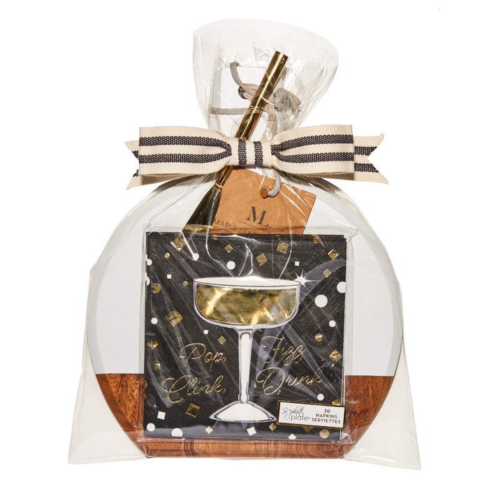 The Maple 9.75" x 8" Board Gift Kit: Gold Disco includes an acacia wood charcuterie board, gold straw, black napkins with “Pop, Clink, Fizz, Durr!” in gold and white print, all wrapped in clear plastic with a black and white ribbon.