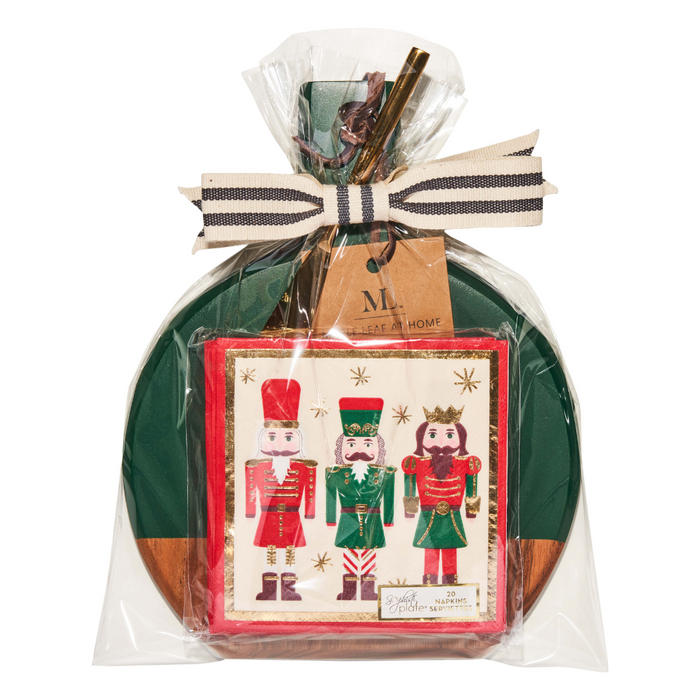 The Maple 9.75" x 8" Board Gift Kit: Nutcracker Christmas includes a festive card with three illustrated nutcrackers, gold stars, cinnamon sticks, ribbon, and tag—ideal to pair with Nutcracker Christmas cocktail napkins.