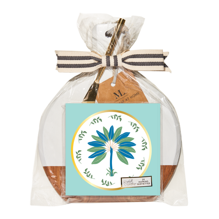 The Sophistiplate 9.75" x 8" Board Gift Kit: Preppy Palm features an acacia wood charcuterie board, gold-tone cheese knife, and illustrated napkins with a blue and green palm design, all wrapped in clear plastic with a striped ribbon.