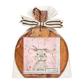 The Sophistiplate 9.75" x 8" Charming Easter Board Gift Kit features a round acacia wood board wrapped in plastic with a black and white ribbon, plus cocktail napkins with a watercolor bunny on pink florals—perfect for gifting.