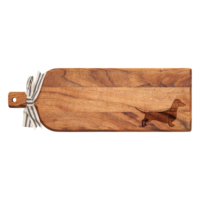 The Maple Acacia Bevel Board Long (20 x 7") features a handle, striped ribbon, gold spreader, and an engraved dachshund silhouette on one end.