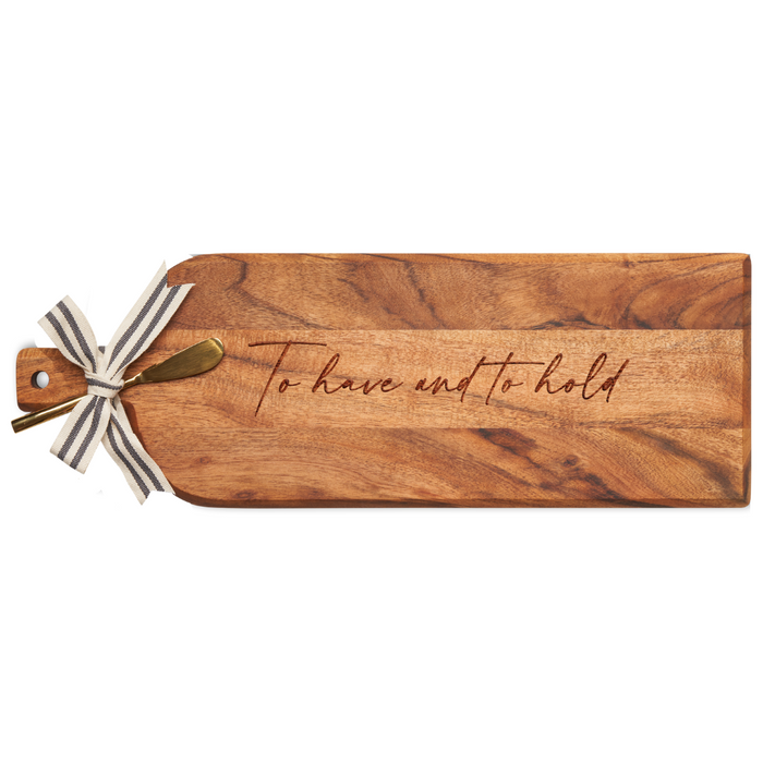 The Maple Acacia Bevel Board Long (20 x 7") is engraved with "To Have And To Hold" and comes with a gold spreader and a black and white striped ribbon at the handle end.