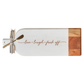 The Maple Acacia Bevel Board Long White (20x7") features "live • love • fuck off" in cursive, a striped ribbon, and a gold spreader—an eye-catching charcuterie board for bold hosts.