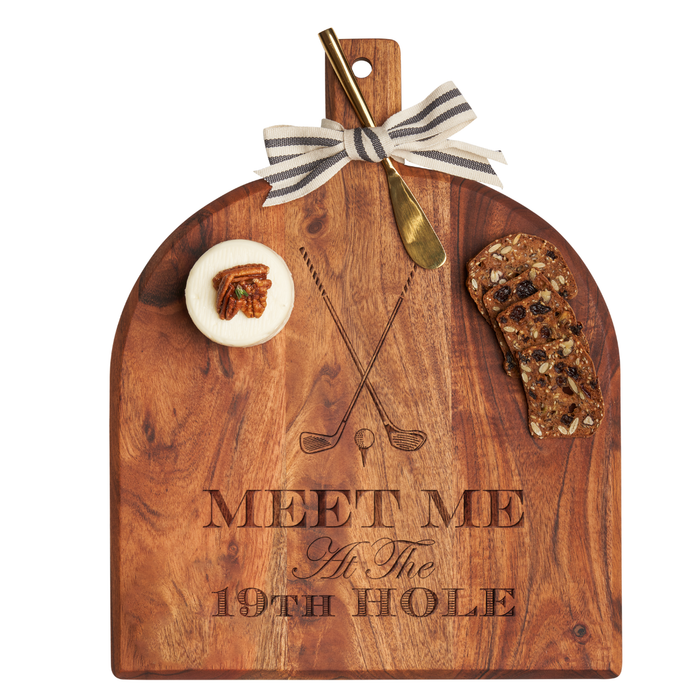 The Maple Acacia Bevel Board (15x12") features "Meet Me at the 19th Hole" with crossed golf clubs, a gold spreader knife tied with ribbon, a round cheese topped with pecan, and two slices of fruit and nut bread.