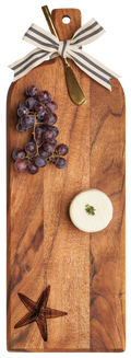 The Maple Acacia Bevel Board (20 x 7") with ribbon, starfish, and gold spreader knife is ideal for stylish entertaining—just add cheese and grapes for a chic charcuterie setup.