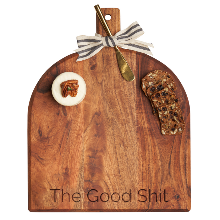 The Maple Acacia Bevel Board w/ Ribbon & Gold Spreader Knife | The Good Shit | 15 x 12" features a beveled edge and comes topped with round cheese, pecans, fruit and nut bread, and a brass spreader tied with a striped ribbon.
