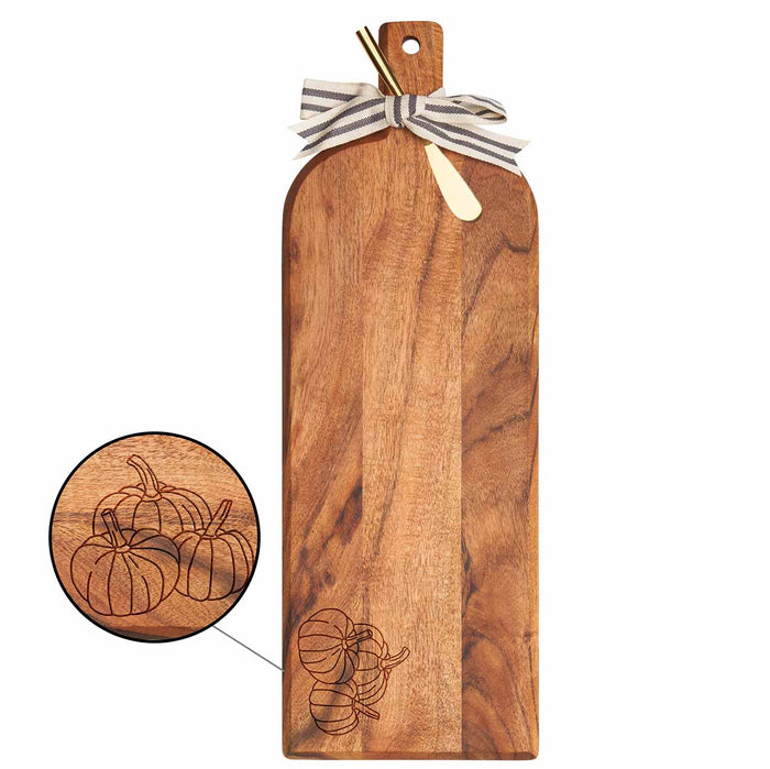 The Maple Acacia Bevel Board w/ Ribbon & Gold Spreader Knife features an engraved three-pumpkin design—measuring 20 x 7", it's a stylish serving board ideal for festive gatherings.