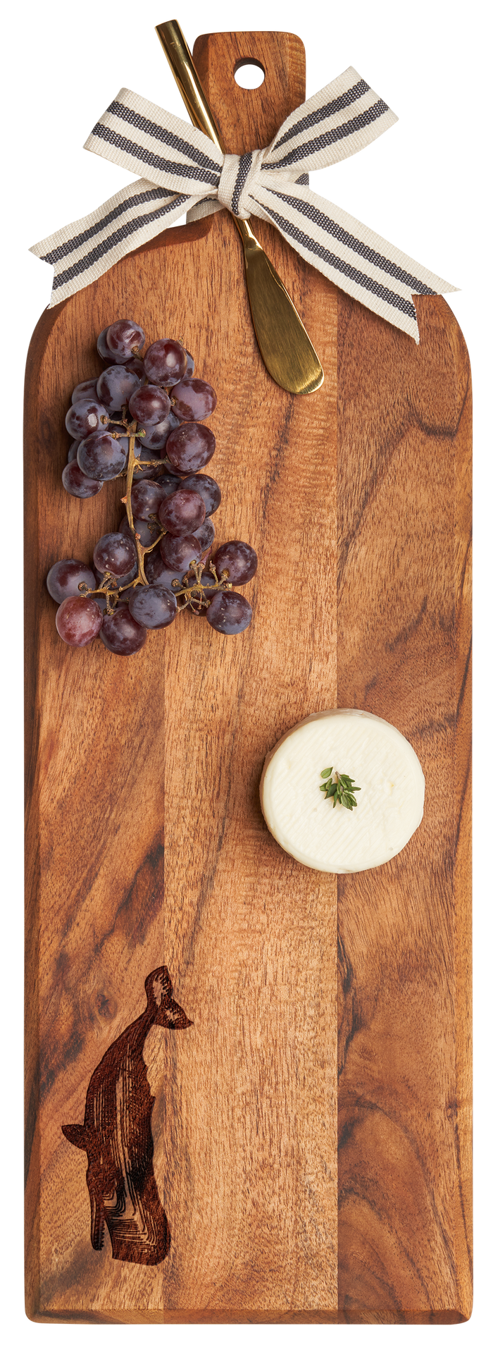 The Maple Acacia Bevel Board w/ Ribbon & Gold Spreader Knife | Whale | 20 x 7" is a wooden serving tray decorated with a ribbon, gold knife, red grapes, and herb-soft cheese on top. Features an engraved whale design.