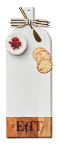 The Maple Acacia Bevel Board White w/ Ribbon & Gold Spreader Knife (20 x 7", engraved with "Eat") features a white and acacia design, striped ribbon bow, and includes a gold knife—perfect for stylish cheese and cracker serving.