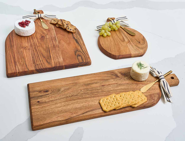 The Maple Acacia Bevel Board with Handle (15 x 12") features a gold ribbon and gray/white spreader, can be personalized with a monogram, and is perfect for stylish entertaining.