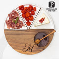 The Maple Acacia Fête Set Round | Personalized | 12" features a monogrammed wood board with ceramic snack dishes for prosciutto, roasted red peppers, blue cheese with pomegranate seeds, and a honey bowl with dipper.