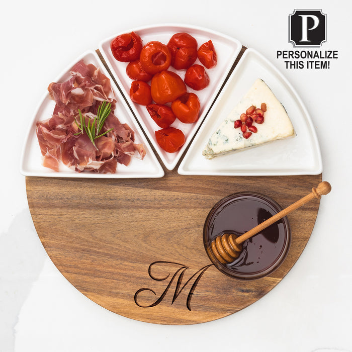 The Maple Acacia Fête Set Round | Personalized | 12" features a monogrammed wood board with ceramic snack dishes for prosciutto, roasted red peppers, blue cheese with pomegranate seeds, and a honey bowl with dipper.
