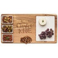 The Maple Acacia Fête Set Tray | Charcuterie Stacked (18" x 9.5") features an acacia wood board engraved “Charcuterie" and ceramic dishes for cheese, grapes, nut mix, olives, almonds, and crackers—perfect for stylish entertaining.