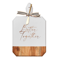 The Maple Acacia Heirloom Board Rectangle in white (16 x 10") features "Better Together" gold script, a wood base, and comes with a gold spreader tied to the handle with a black and white striped ribbon.