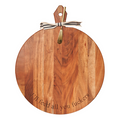 The Maple Acacia Heirloom Board, 20 x 16", is a round charcuterie board with a gold spreader and striped ribbon, engraved with “I’ll Feed All You Fuckers”—a bold statement piece for stylish entertaining.