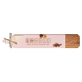 The Maple Acacia Heirloom Board Skinny in pink, featuring a wood design and engraved with "Get Your Mahj On" mahjong tiles (34 x 6"), includes a gold spreader and ribbon—perfect for serving cheese, figs, and nuts at your next gathering.