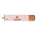 The Maple Acacia Heirloom Board Skinny in pink (34 x 6") features pink and natural wood, "Pickleball" engraving, a pickleball graphic, plus a gold spreader with ribbon—perfect as a playful charcuterie board for any gathering.
