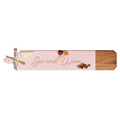 The Maple Acacia Heirloom Board Skinny in pink (34 x 6") features "Sea and Wine" script, with cheese, figs, and nuts on top. Includes a gold spreader tied with ribbon.