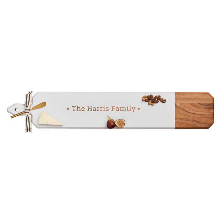 The Maple Acacia Heirloom Board Skinny in white (34 x 6") comes with a gold spreader, ribbon, and can be personalized. Perfect for serving cheese, figs, and pecans.