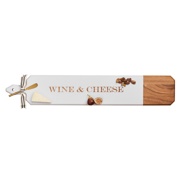 The Maple Acacia Heirloom Board Skinny in white (34" x 6") features "Wine & Cheese" text and comes with a gold spreader and ribbon—stylish and perfect for your next charcuterie spread.