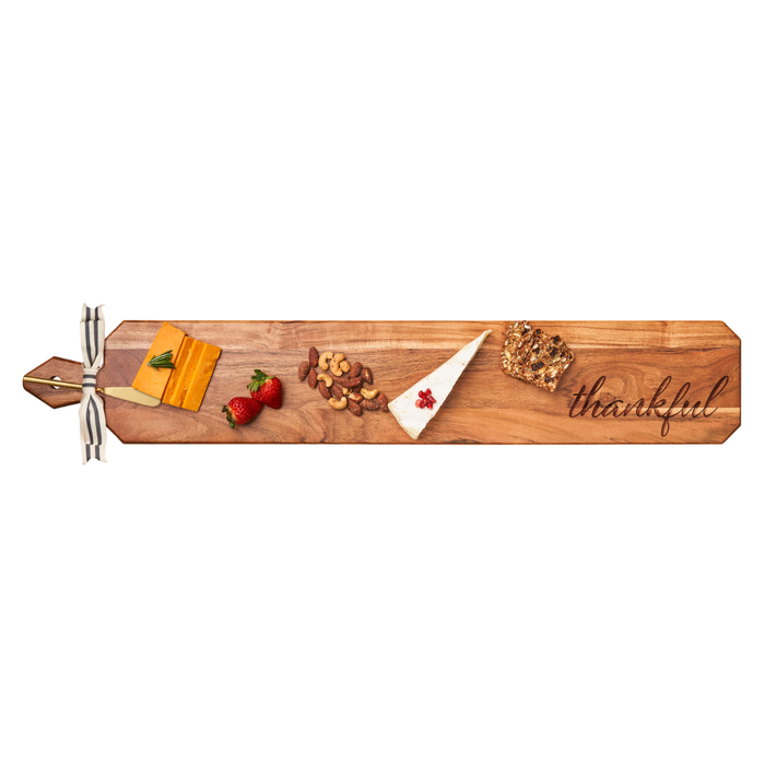 The Maple Acacia Heirloom Board Skinny (34 x 6"), featuring "thankful," comes with a gold spreader and ribbon—ideal for serving cheese, nuts, brie, fruit, and bread at any gathering.