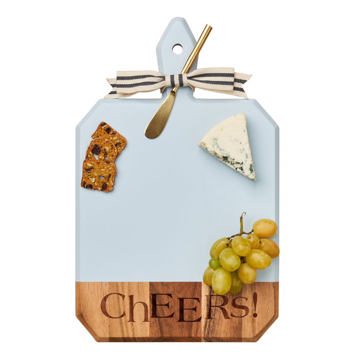 The Maple Acacia Heirloom Board w/ Handle Rectangle in Light Blue (16 x 10", "Cheers!" engraved) is decorated with a striped bow, gold knife, crackers, blue cheese wedge, and green grapes against a white background.