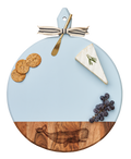The Maple Acacia Heirloom Board with Handle (Whale, 20 x 16") comes with a gold spreader tied with a gray & white ribbon, perfect for serving charcuterie like crackers, cheese, grapes, and more.